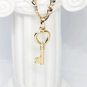 14 karat Yellow Gold Puffy Key Charm in Heart Shape